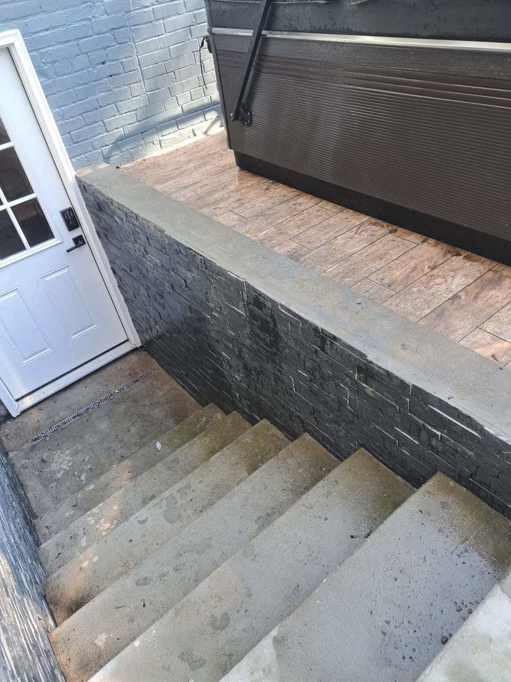 Exterior stone veneer wall and steps completed as part of a full remodel